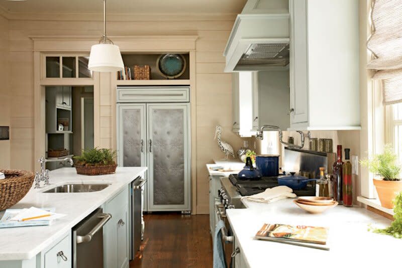 Southern Living Kitchen with seafoam green cabinets, stainless steel appliances, and a peach wall color