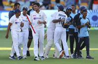 Indian players celebrate after defeating Australia by three wickets on the final day of the fourth cricket test at the Gabba, Brisbane, Australia, Tuesday, Jan. 19, 2021.India won the four test series 2-1. (AP Photo/Tertius Pickard)