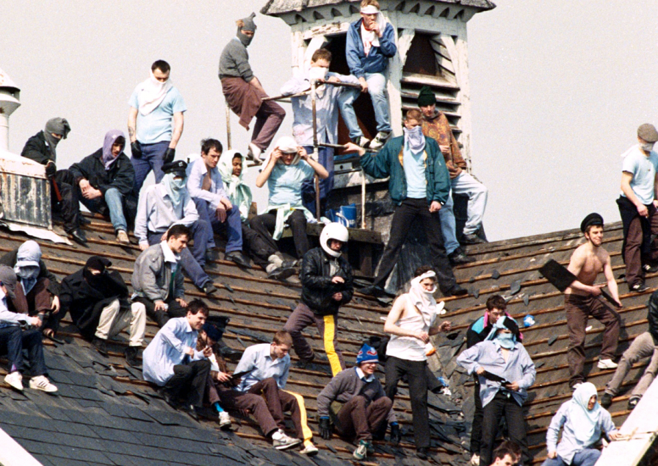 Rioting prisoners congregate on the roof of Manchester's Strangeways prison in 1990 (Rex)