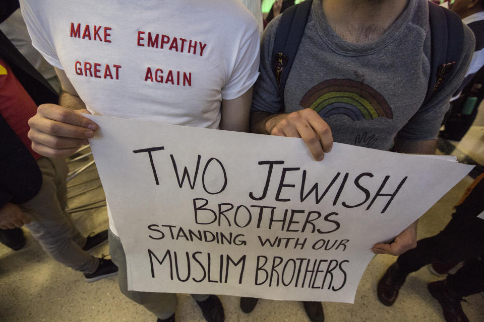 Brothers Adam, left, and Noah Reich show their support if immigrants as they join opponents of Donald Trump's new immigration order at the Tom Bradley International Terminal at LAX on January 29, 2017 in Los Angeles, California.&nbsp;