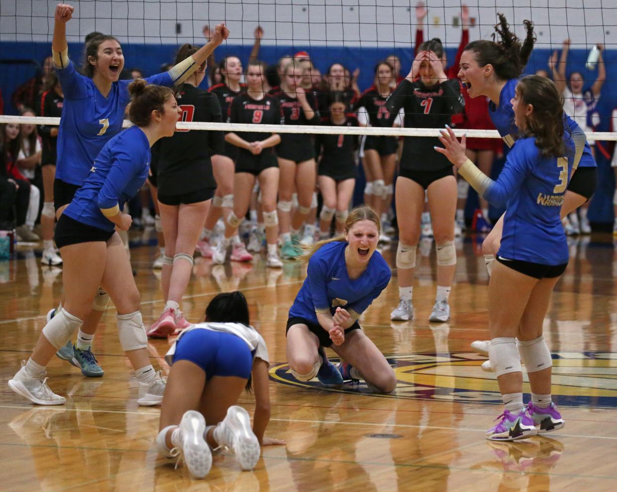 Webster Schroeder players celebrate after the final point giving them the win over Penfield in five sets during their Section V Class AA1 volleyball final Saturday, Nov. 4, 2023 at Victor High School.