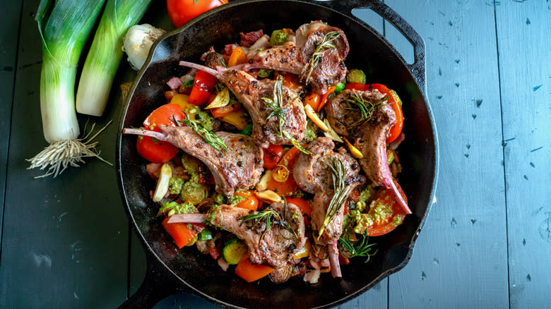 Lamb chops in skillet with veggies