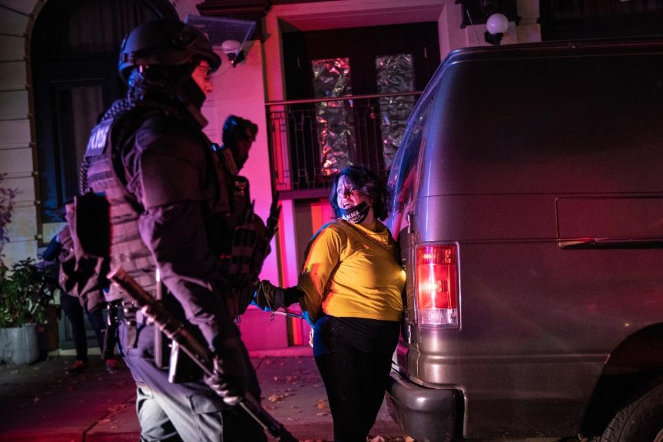 Police arrest a protester in Portland, Ore., during a march following the presidential election on Nov. 4, 2020.