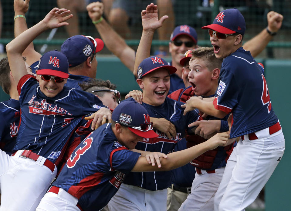 Endwell, N.Y., pitcher Ryan Harlost, center, celebrates with teammates after getting the final out of the Little League World Series Championship baseball game against South Korea in South Williamsport, Pa., Sunday, Aug. 28, 2016. (AP Photo/Gene J. Puskar)