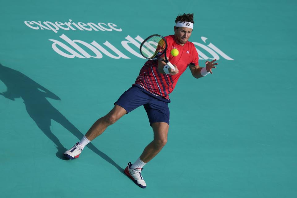 Casper Ruud of Norway returns the ball to Carlos Alcaraz of Spain , during a match for the third place of the Mubadala World Tennis Championship, in Abu Dhabi, United Arab Emirates, Sunday, Dec. 18, 2022. (AP Photo/Kamran Jebreili)