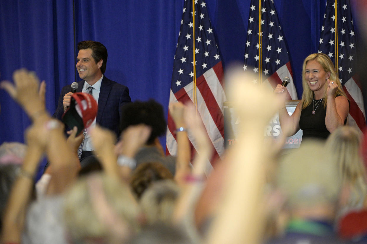 Rep. Matt Gaetz, left, and Rep. Marjorie Taylor Greene address attendees during a rally on May 7 in the Villages, Fla. (Phelan M. Ebenhack/AP)