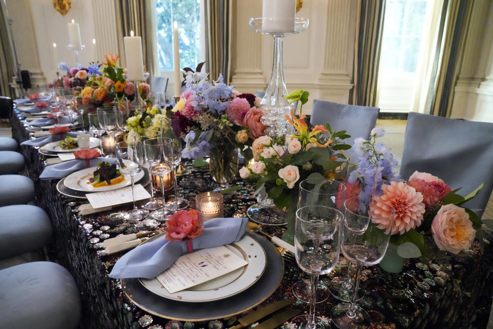 A menu is placed on a table setting for the State Dinner on Wednesday with Australia's Prime Minister Anthony Albanese is seen in the State Dining Room during a media preview Tuesday, Oct. 24, 2023, at the White House in Washington. (AP Photo/Mark Schiefelbein)