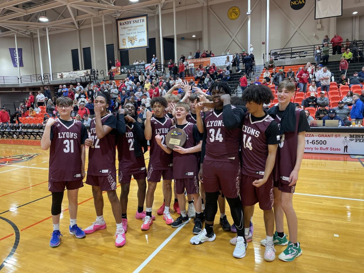 Lyons senior point guard Mikey Briggs hold the region championship plaque after his Lions defeated reigning state champion Section VI's Randolph 61-49 in the NYSPHSAA Class C region final Friday, March 8, 2024 at Buffalo State University.