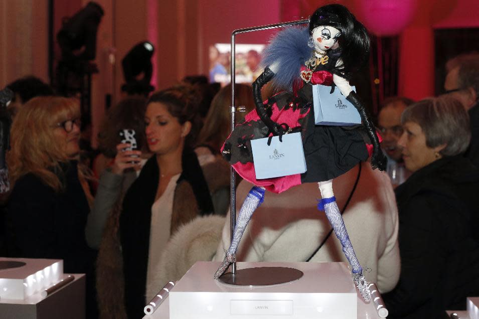 A doll is displayed by Lanvin fashion house in Paris, Monday Nov. 25, 2013. The world's top fashion houses from Chanel, Prada and Christian Dior have brought together their needlework in a unique charitable venture: each designing children's dolls that will be sold at auction for UNICEF. (AP Photo/Francois Mori)