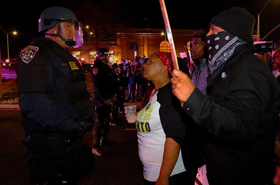 Tanya Faison, in white shirt, confronts police officers during a Black Lives Matter protest. Faison is founder of the Black Lives Matter Sacramento chapter in California.