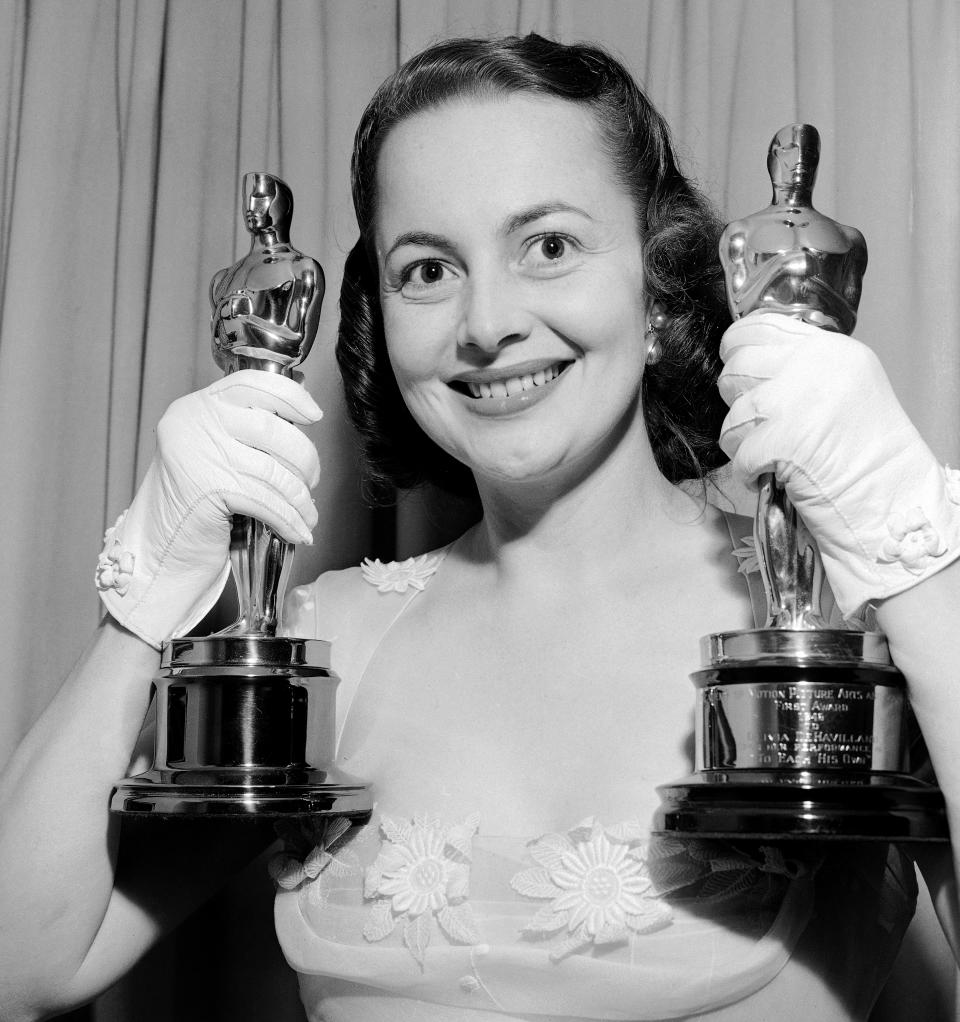 Olivia de Havilland won Hollywood's highest cinema award for the second time when she was awarded an Oscar for her performance in "The Heiress." She won her first statuette in 1946 for “To Each His Own." She is smiling happily with her two Oscars as she returned to her home after the Academy Awards Presentations on March 24, 1950. (AP Photo)