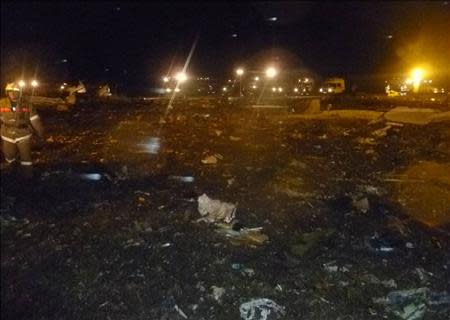 An emergency worker walks at the scene of a Boeing 737-500 crash at Kazan airport November 17, 2013 in this handout photograph provided by the Russian Emergencies Ministry. REUTERS/Russian Emergencies Ministry/Handout