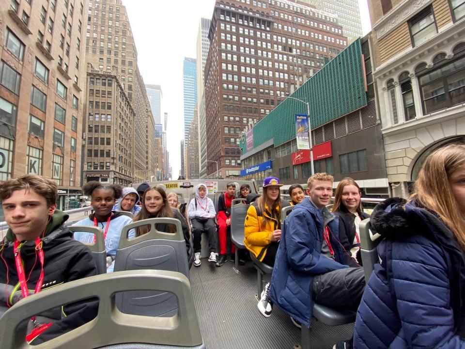 image of students on a double-decker tour bus in NYC