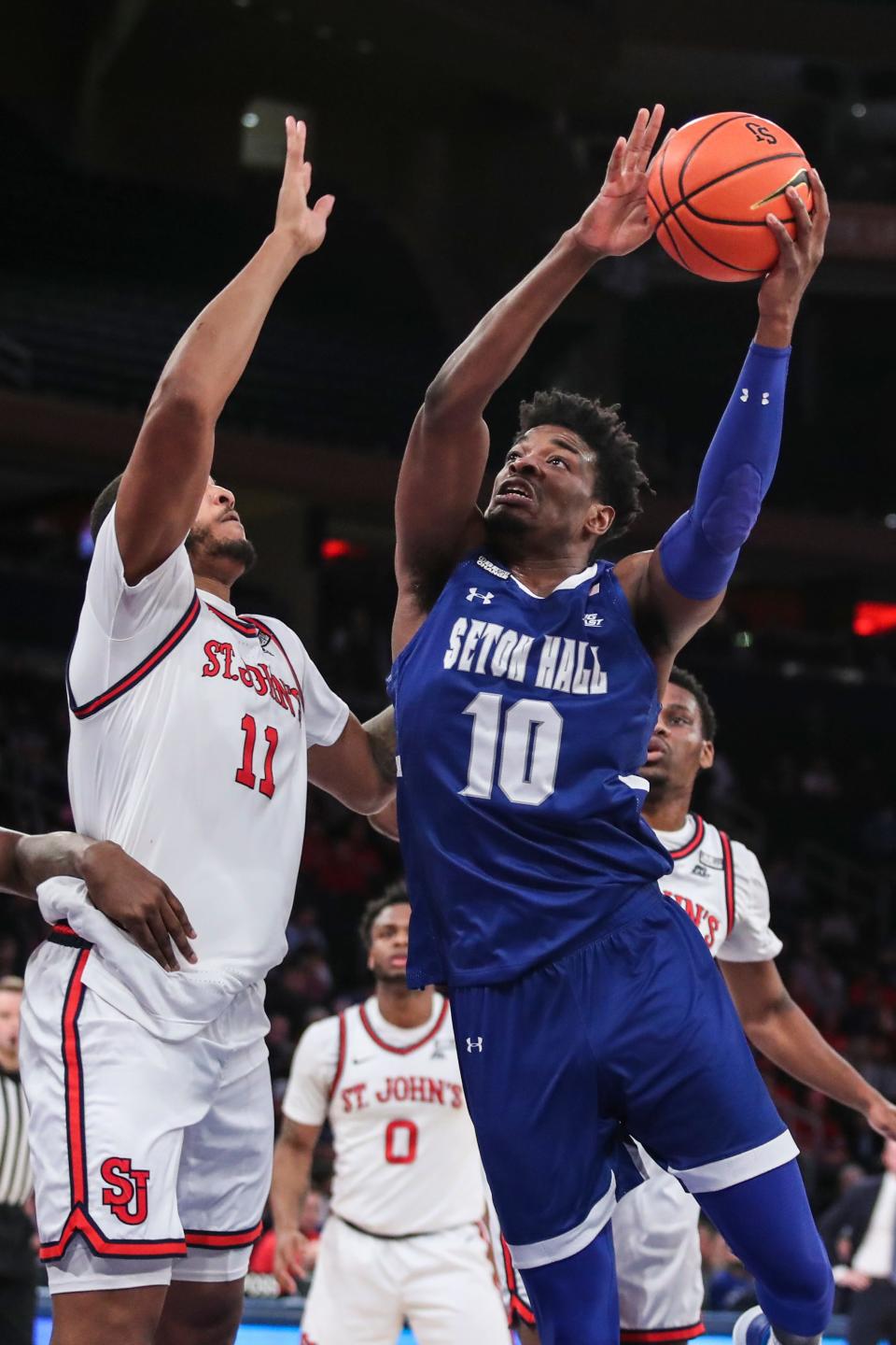 Seton Hall Pirates forward Alexis Yetna (10) goes up against St. John's Red Storm center Joel Soriano (11)