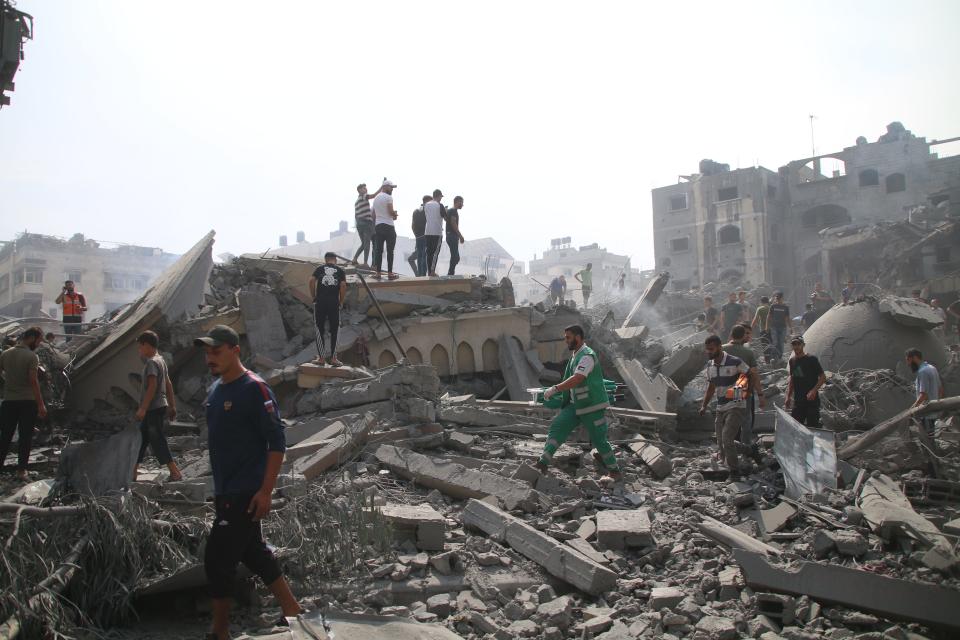Palestinian citizens inspect the damage to the Al-Sussi Mosque and their homes following Israeli air strikes in the Al-Shati Palestinian refugee camp on Monday in Gaza City, Gaza. Almost 500 people have died in Gaza after Israel launched sustained retaliatory air strikes after Saturday's attack by Hamas.
