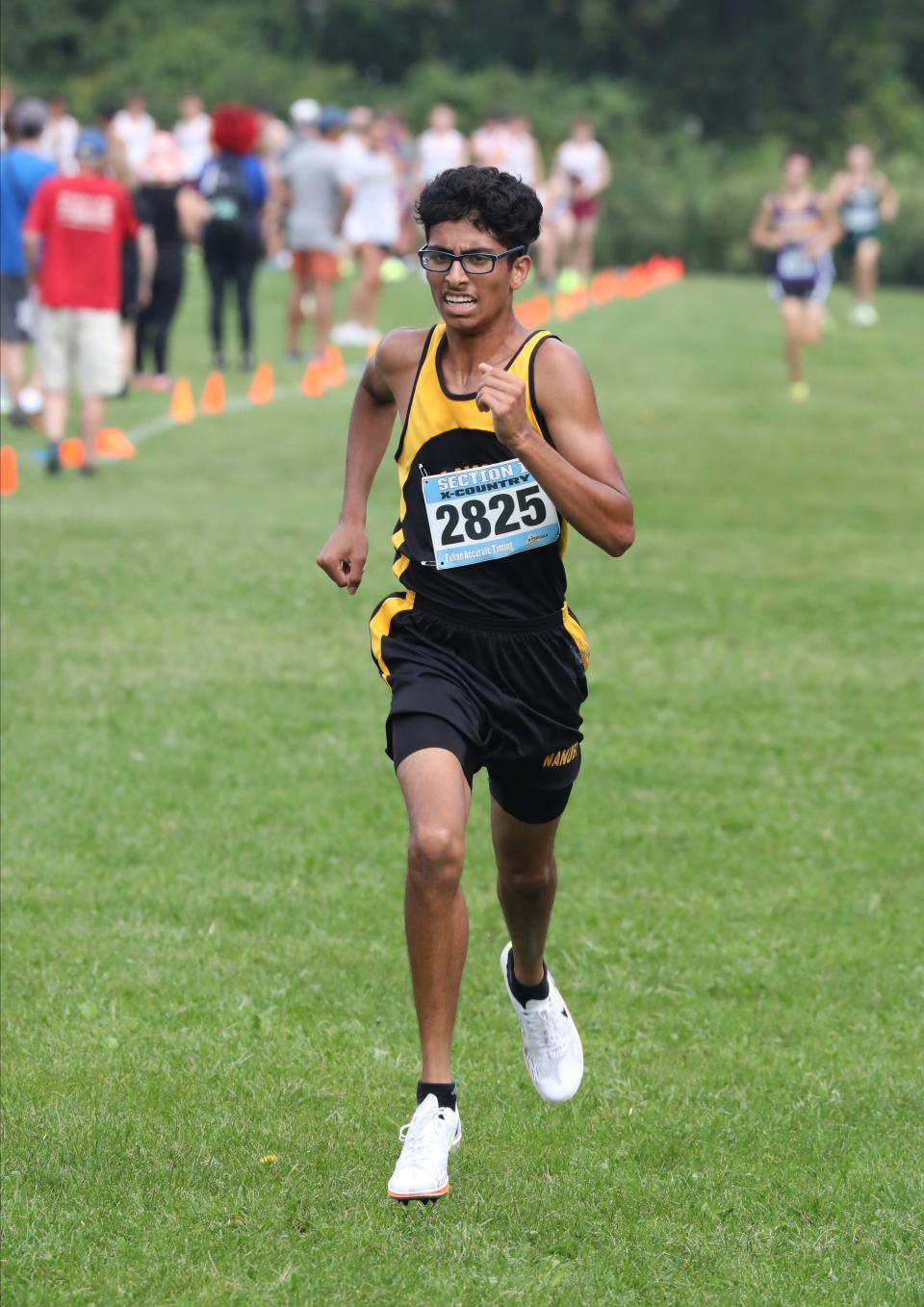 Shane Ethakkan from Nanuet crosses the finish line in the boys D2 race at the Somers Big Red Invitational Cross Country meet at Somers High School, Sept. 9, 2023.