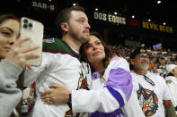 Arizona Coyotes season-ticket holders comfort one another as time expires in team's NHL hockey game against the Edmonton Oilers on Wednesday, April 17, 2024, in Tempe, Ariz. The Coyotes won 5-2. Coyotes owner Alex Meruelo agreed to sell the franchise's hockey operations to Utah Jazz owner Ryan Smith, who intends to move the team to Salt Lake City. (AP Photo/Ross D. Franklin)