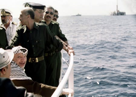 FILE PHOTO: Palestinian President Yasser Arafat sails off to take part in a ceremony to symbolically ignite the Palestinians' first offshore gas well, at the Mediterranean Sea off the coast of Gaza Strip