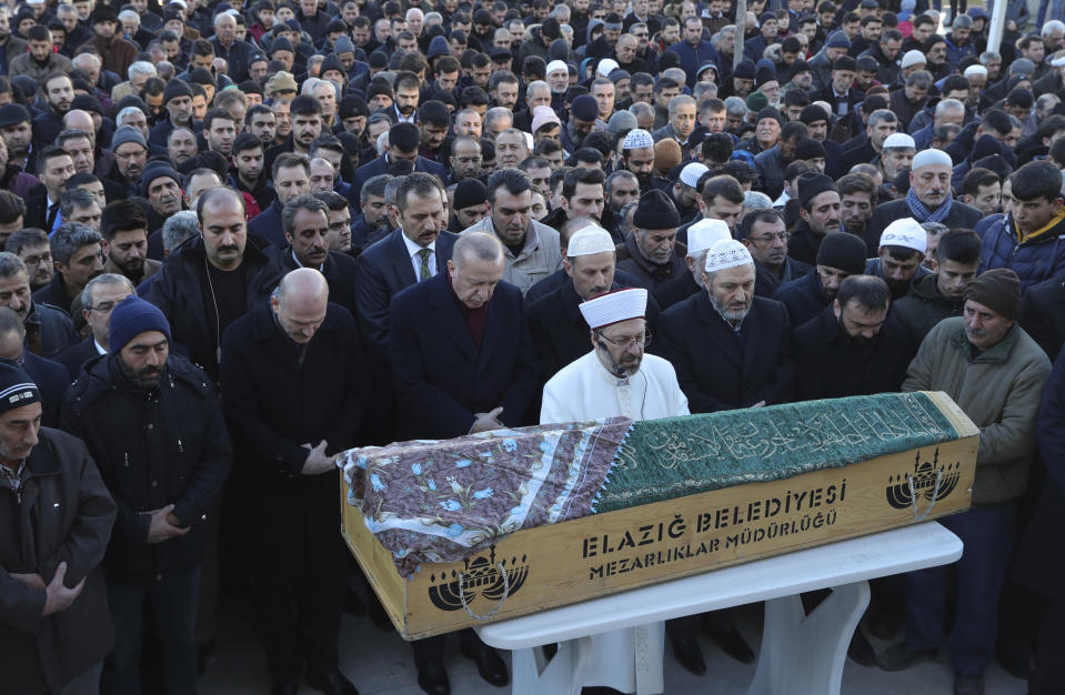 Turkey's President Recep Tayyip Erdogan, centre, attends q funeral procession for Salih Civelek and Aysegul Civelek, victims of Friday's earthquake in Elazig, eastern Turkey, Friday, during the Saturday, Jan. 25, 2020. Rescue workers were continuing to search for people buried under the rubble of apartment blocks in Elazig and neighbouring Malatya. Mosques, schools, sports halls and student dormitories were opened for hundreds who left their homes after the quake (Presidential Press Service via AP, Pool)