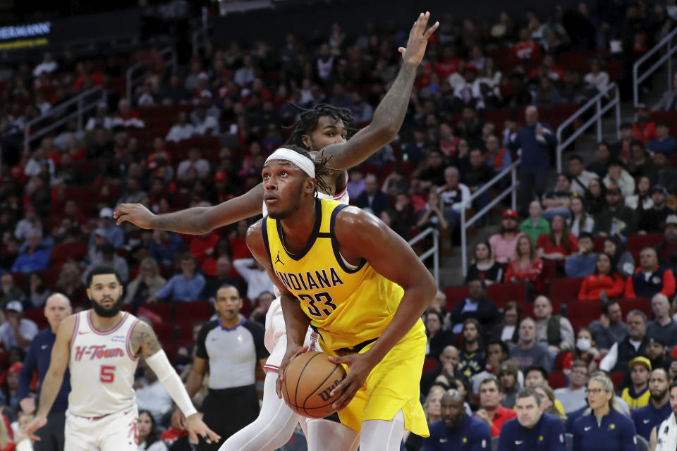 Indiana Pacers center Myles Turner, front, looks for a shot next to Houston Rockets forward Tari Eason during the first half of an NBA basketball game Tuesday, Dec. 26, 2023, in Houston. (AP Photo/Michael Wyke)