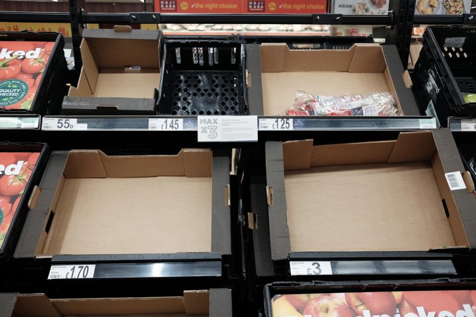 Empty fruit and vegetable shelves at an Asda in east London (PA)