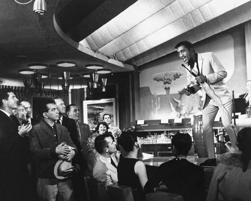 Pepe, played by Mexican actor and comedian Cantinflas (1911 - 1993, fourth from left), in the audience during a performance by Sammy Davis Jr (1925 - 1990), as himself, in 'Pepe', directed by George Sidney, 1960. (Photo by Silver Screen Collection/Getty Images)