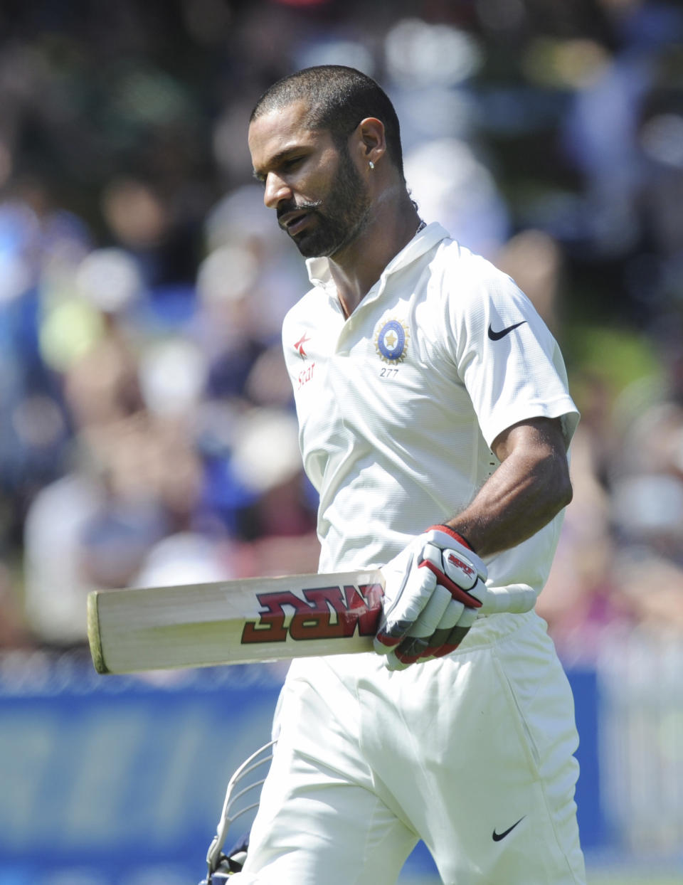 India’s Shikar Dhawan walks, out for 98 off the bowling of New Zealand’s Tim Southee on the second day of the second cricket test in Wellington, New Zealand, Saturday, Feb. 15, 2014. (AP Photo/SNPA, Ross Setford) NEW ZEALAND OUT