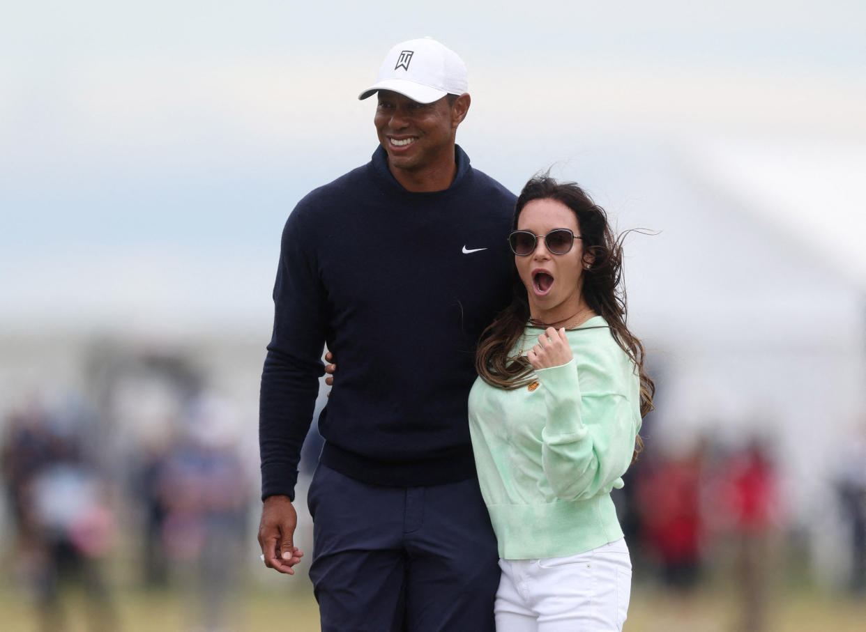 Golf - The 150th Open Championship - Old Course, St Andrews, Scotland, Britain - July 12, 2022 Tiger Woods of the U.S. poses with his partner, Erica Herman, during practice REUTERS/Paul Childs