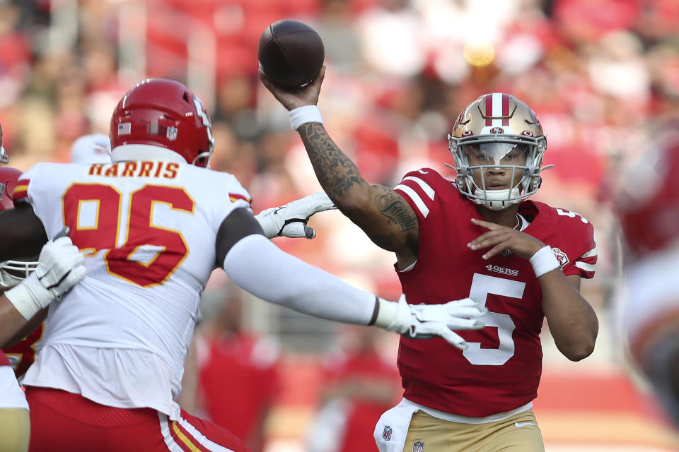 San Francisco 49ers quarterback Trey Lance (5) passes against Kansas City Chiefs defensive end Demone Harris (96) during the first half of an NFL preseason football game in Santa Clara, Calif., Saturday, Aug. 14, 2021. (AP Photo/Jed Jacobsohn)