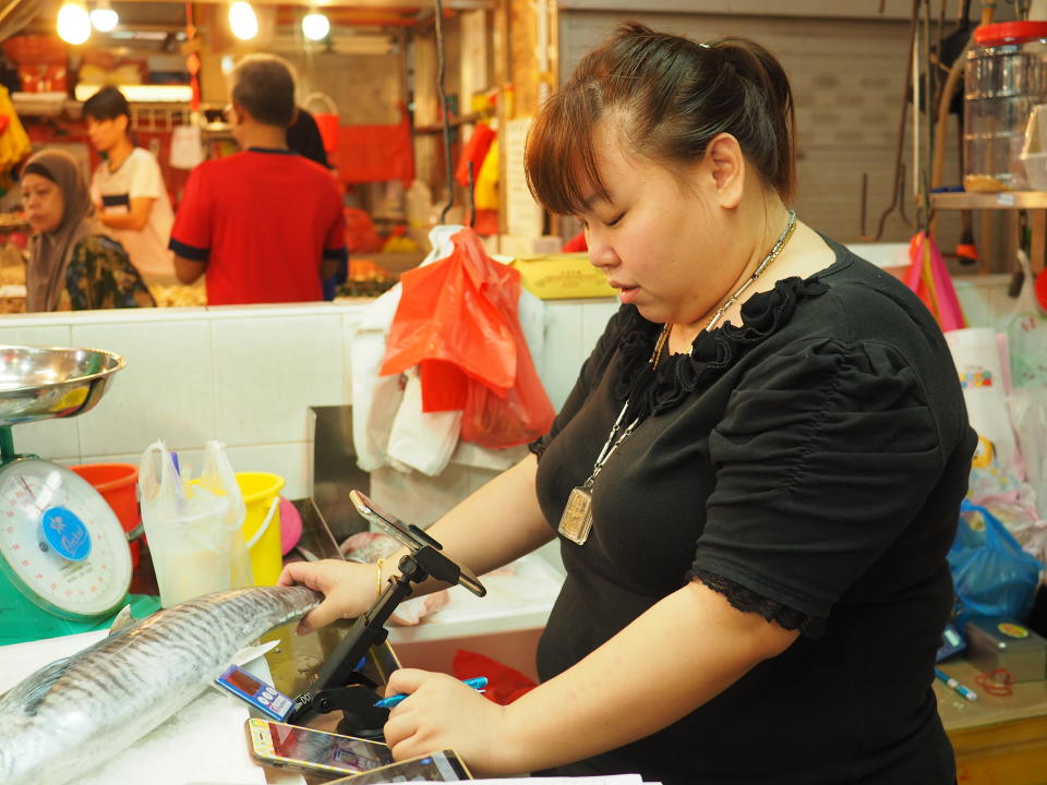 Christina Tan, 28, has been helping her father sell fresh seafood since she was 18. (Photo: Nurul Azliah/Yahoo Lifestyle Singapore)