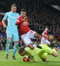 PSV Eindhoven's goalkeeper Jeroen Zoet saves the ball from Manchester United's midfielder Jesse Lingard (Top C) during a UEFA Champions League match at Old Trafford Stadium in Manchester, north west England on November 25, 2015