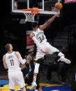 Milwaukee Bucks forward Giannis Antetokounmpo (34) blocks a shot by Brooklyn Nets guard Kyrie Irving (11) during the first half Game 2 of an NBA basketball second-round playoff series, Monday, June 7, 2021, in New York. Milwaukee Bucks center Brook Lopez (11) looks on. (AP Photo/Kathy Willens)