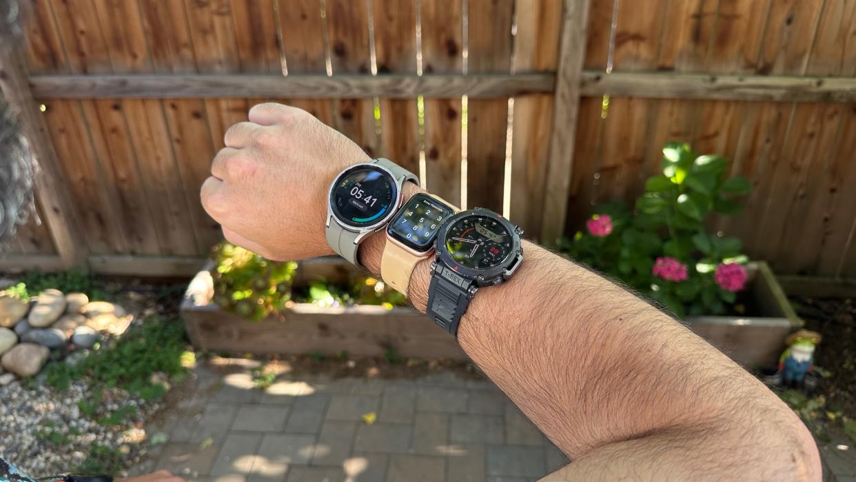  Three smartwatches worn on one wrist for a step-counting accuracy test.  