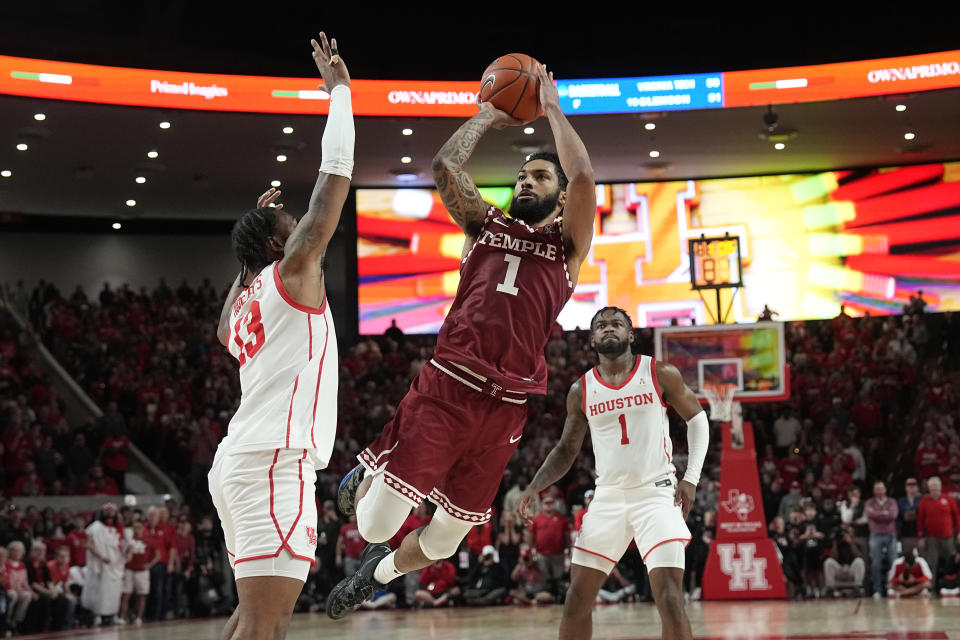 Temple's Damian Dunn (1) shoots as Houston's J'Wan Roberts (13) defends during the second half of an NCAA college basketball game Sunday, Jan. 22, 2023, in Houston. Temple won 56-55. (AP Photo/David J. Phillip)