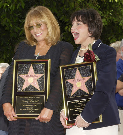 FILE PHOTO: Penny Marshall (L), and Cindy Williams, who co-starred in the 1970s hit TV series "Laverne & Shirley" pose following a rare two-star unveiling ceremony honoring them with the 2,258th and 2,259th stars on the Hollywood Walk of Fame August 12, 2004. Laverne and Shirley were portrayed by Marshall and Williams respectively. REUTERS/Jim Ruymen/File Photo