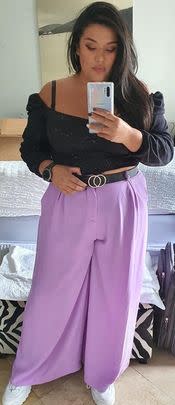 A pair of high-waisted trousers with wide legs and an elastic waistband