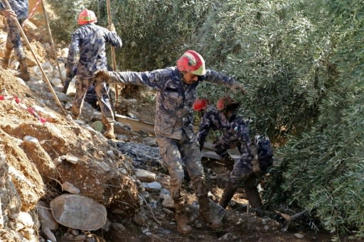 Jordanian rescue teams search for missing persons following flash floods in the city of Madaba near the capital Amman on November 10, 2018