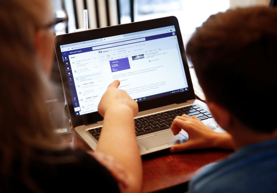 Chrissy Brackett and grandson Caidence Miller, a 4th grader at Cottage Lake Elementary, struggle to navigate the online learning system the Northshore School District will use for two weeks due to coronavirus concerns, at Brackett's home in Woodinville, Washington, U.S. March 11, 2020. Brackett is watching Caidence while his mother works at a preschool during the day.  REUTERS/Lindsey Wasson