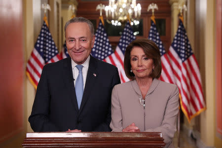 U.S. Speaker of the House Nancy Pelosi and Senate Minority Leader Chuck Schumer pose for photographers after concluding their joint response, to President Trump's prime time address, on Capitol Hill in Washington, U.S., January 8, 2019. REUTERS/Jonathan Ernst