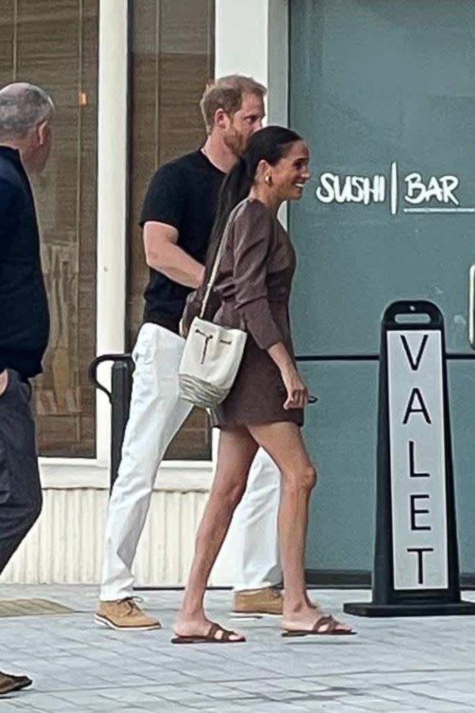 Meghan Markle wearing a mini brown dress