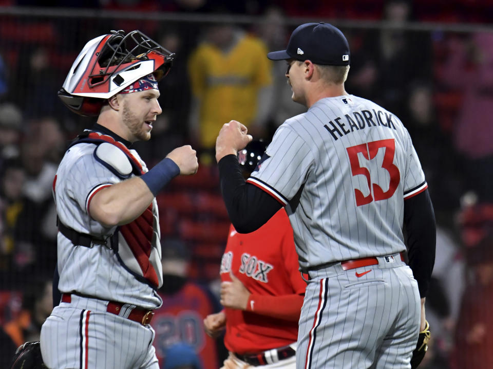 Minnesota Twins catcher Ryan Jeffers and pitcher Brent Headrick fist-bump after the team's win over the Boston Red Sox in baseball game at Fenway Park, Wednesday, April 19, 2023, in Boston. (AP Photo/Mark Stockwell)