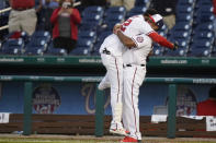 Washington Nationals' Juan Soto, left, celebrates with manager Dave Martinez after Soto hit a game-winning single in the ninth inning of an opening day baseball game against the Atlanta Braves at Nationals Park, Tuesday, April 6, 2021, in Washington. Victor Robles scored on the play, and Washington won 6-5. (AP Photo/Alex Brandon)