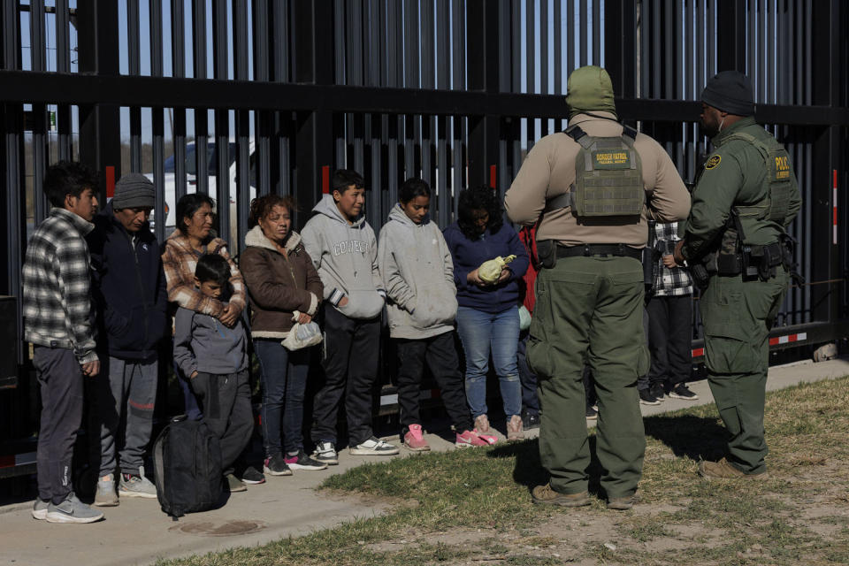 U.S. Border Patrol agents guard migrants that crossed into Shelby Park as they wait to be picked up for processing in Eagle Pass, Texa (Michael Gonzalez / Getty Images)