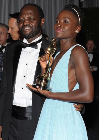 <p>VALERIE MACON/AFP/Getty</p> Lupita Nyong'o and Peter Anyang' Nyong'o at the Governor's Ball following the 86th Academy Awards on March 2, 2014.