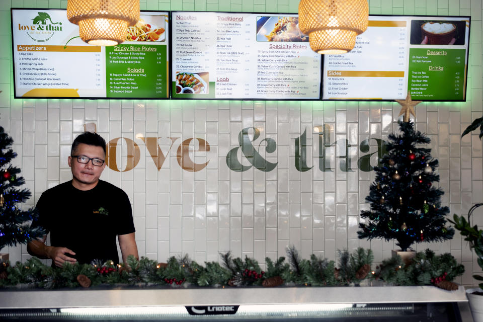 David Rasavong waits for luncheon customers behind the counter at his restaurant "Love & Thai" in Fresno, Calif. on Wednesday, Dec. 20, 2023. (AP Photo/Richard Vogel)