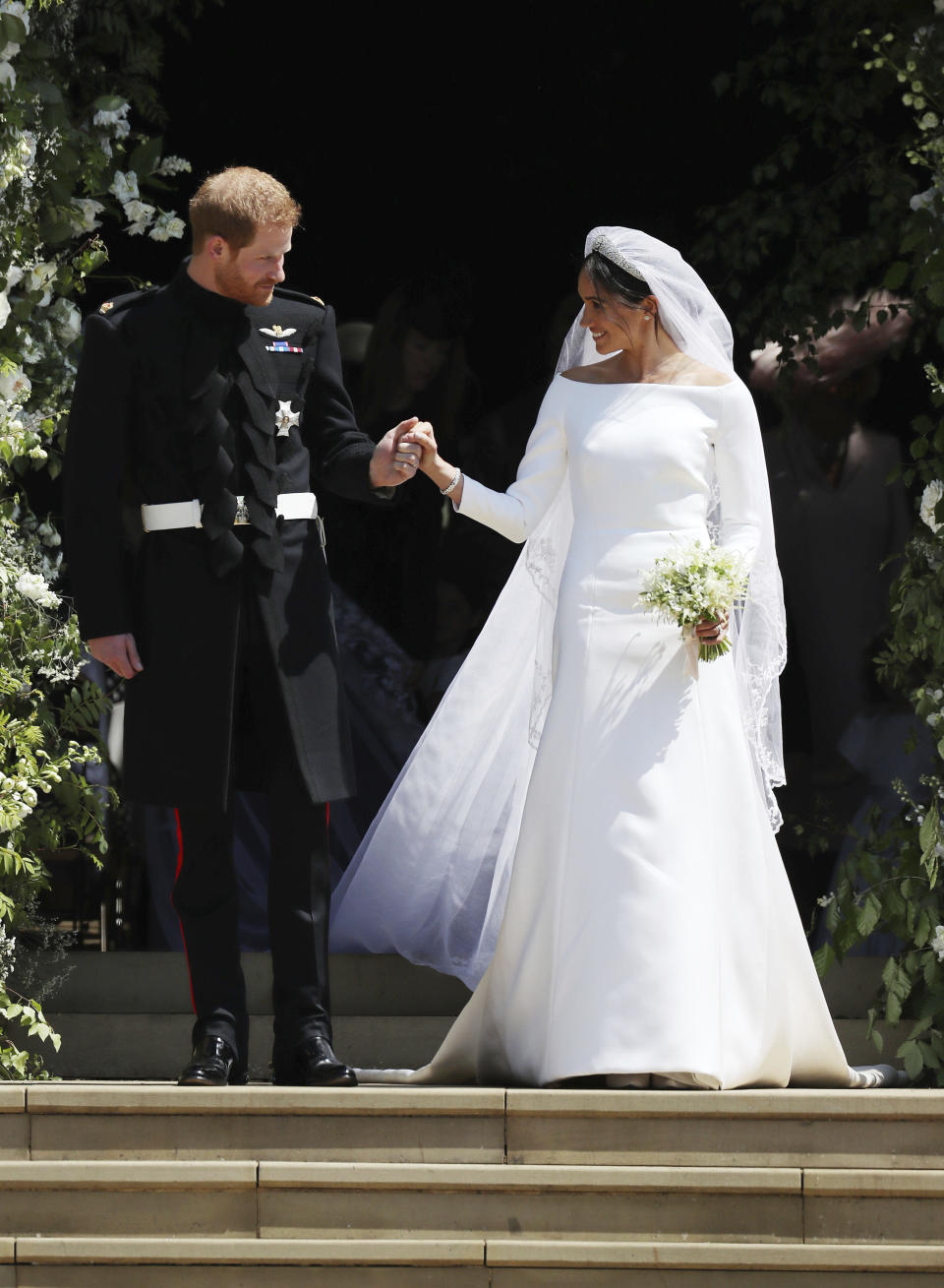 FILE - In this May 19, 2018, file photo, Meghan Markle and Britain's Prince Harry walk down the steps of St George's Chapel at Windsor Castle in Windsor, near London, England, following their wedding. (Jane Barlow/pool photo via AP, File)