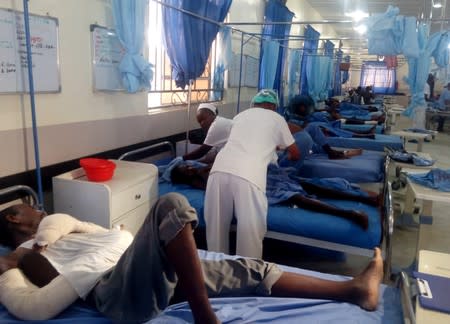 Injured people receive treatment inside a hospital in Maiduguri, after a triple suicide attack in northeast Nigerian state of Borno