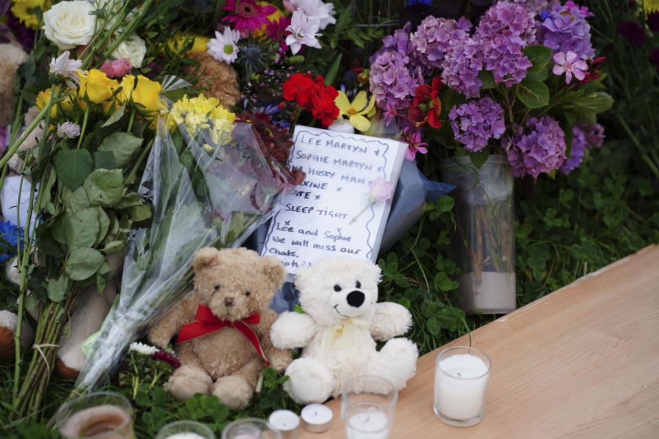 Bouquets of flowers and stuffed toys are placed Saturday, Aug. 14, 2021 in the Keyham area of Plymouth, England, where a young man who killed five people and then took his own life on Thursday. Police said the motive for the shootings was unclear but there were no immediate signs that the crime was an act of terrorism. (Ben Birchall/PA via AP)