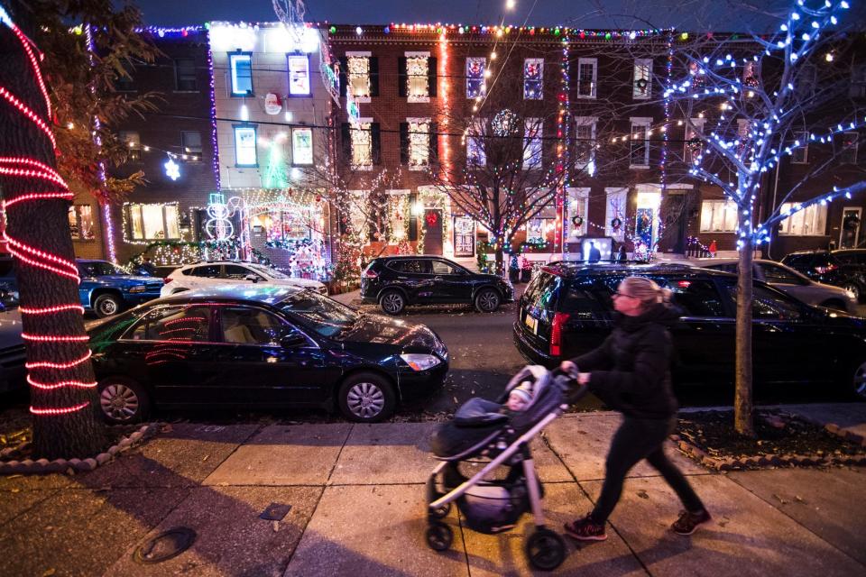 Homes are decorated for what the neighborhood calls its annual Miracle on South 13th Street holiday lights display in Philadelphia, Monday, Dec. 17, 2018.