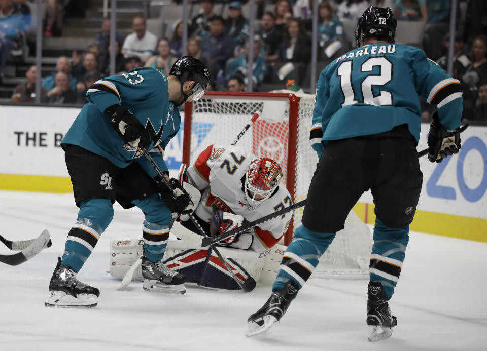 Florida Panthers goalie Sergei Bobrovsky (72) blocks a shot from San Jose Sharks' Patrick Marleau (12) during the first period of an NHL hockey game Monday, Feb. 17, 2020, in San Jose, Calif. At left is Sharks' Barclay Goodrow (23). (AP Photo/Ben Margot)